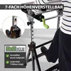 A person is using a foldable workbench with a crank mechanism for height adjustment. Produktbild-Vorschau