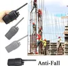 Construction workers on a building site, with walkie-talkies shown in the foreground. Náhled obrázku produktu