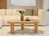 A modern living room scene with a large, light-colored sectional sofa and a wooden coffee table. Anteprima dell’immagine prodotto