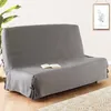 A sofa cover on a sofa, with a book on it, in a room setting. Produktbild-Vorschau
