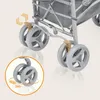 Close-up of the wheels and frame of a stroller, with an inset showing a detail of the front wheels rotating. Produktbild-Vorschau