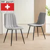 Two gray upholstered dining chairs with black metal legs are shown in a room with light wood paneling in the background. Produktbild-Vorschau