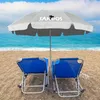 Two blue beach chairs and a gray umbrella on a sandy beach with the ocean and sky in the background. Náhled obrázku produktu