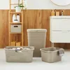 A collection of laundry baskets and a shelf with bathroom items. Produktbild-Vorschau