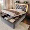 A bed with its storage compartment open, showing stored items. Náhľad obrázku produktu