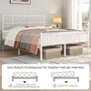 A white metal bed frame with bedding is shown, with diagrams illustrating features below. Two storage baskets are placed underneath the bed. Podgląd zdjęcia produktu