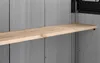 A close-up view of a wooden shelf mounted on a gray wall inside a storage unit. Anteprima dell’immagine prodotto