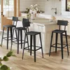 A set of black bar stools arranged around a kitchen island. Produktbild-Vorschau