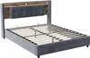 A grey upholstered bed frame with a headboard featuring built-in storage and LED lighting, shown without a mattress. Voir les images du produit
