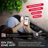 A person is using a smartphone while lying on a fitness device, with plants in the background. Produktbild-Vorschau