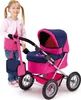 A young girl stands next to a pink and blue doll stroller. Produktbild-Vorschau
