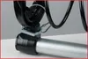 A close-up view of a mechanical component, likely part of a tool or machinery, showing a black metal bracket attached to a silver metal tube with a cable securing it. Voir les images du produit