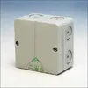A gray electrical junction box is shown against a light gray and white background. Náhled obrázku produktu