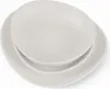A stack of white plates and bowls on a white background. Voir les images du produit