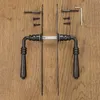 Door handles and hardware laid out on a wooden surface. Produktbild-Vorschau