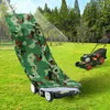 A camouflage lawn mower cover is draped over a lawn mower in a grassy yard with trees in the background. Produktbild-Vorschau