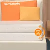 A mattress with two pillows on top, set against a neutral background with vertical wood paneling. Produktbild-Vorschau