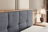 Close-up of a bed headboard and a bedside lamp. Produktbild-Vorschau