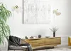 A modern living room scene featuring a wooden media console, a chair with a blanket, and wall lamps. Produktbild-Vorschau