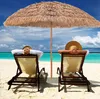Two people relaxing on beach chairs under a thatched umbrella on a sandy beach with the ocean and sky in the background. Produktbild-Vorschau
