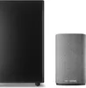 A black rectangular speaker and a gray cylindrical speaker are placed side-by-side against a white background. Produktbild-Vorschau