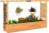 A wooden raised garden bed with a trellis and hanging planters, filled with various plants. Anteprima dell’immagine prodotto