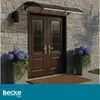 A double door entrance with a canopy, flanked by potted plants. Náhled obrázku produktu