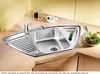 A corner kitchen sink with a faucet, drainboard, and a small bowl of salad. Náhľad obrázku produktu