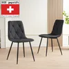 Two black dining chairs are shown in a room with a light-colored wall and wooden paneling in the background. Náhled obrázku produktu