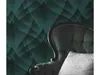 A close-up of a tufted armchair with a white pillow in front of a teal and black patterned wallpaper. Produktbild-Vorschau