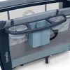 A close-up view of a baby crib organizer with multiple compartments. Produktbild-Vorschau