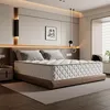 A bedroom scene with a mattress on a bed frame, bedside table, and artwork on the wall. Voir les images du produit