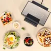 A waffle maker with several waffles prepared with various toppings, arranged around it. Anteprima dell’immagine prodotto