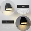 Collage showing two solar-powered wall lights mounted on a textured wall, with accompanying text descriptions. Produktbild-Vorschau