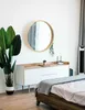 A bedroom scene with a dresser, mirror, plant, and bed. Náhled obrázku produktu