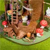 A miniature, whimsical treehouse scene with a cat figurine, mushrooms, and a ladder. Podgląd zdjęcia produktu