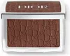 A close-up, top-down view of a Dior bronzer compact. Voir les images du produit
