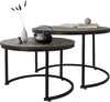 Two nesting coffee tables with a dark wood top and black metal legs, decorated with a teapot, a vase with dried flowers, and books. Produktbild-Vorschau