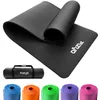A black yoga mat is shown unrolled, with a portion rolled up, and a black carrying bag. Below are several rolled-up mats in different colors. Podgląd zdjęcia produktu