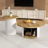 Two round coffee tables with wooden tops and white ribbed bases are placed on a textured rug in a living room setting. A credenza and television are visible in the background. Produktbild-Vorschau