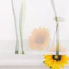 A close-up view of sunflowers behind a sheer curtain with green stripes. Produktbild-Vorschau