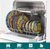 A set of colorful, patterned plates stacked in a dishwasher rack. Produktbild-Vorschau