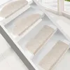 Several cream-colored stair mats are placed on white stairs. Náhled obrázku produktu