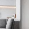 A close-up view of a gray sofa with a shelf in the background. Anteprima dell’immagine prodotto