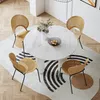 A dining table and chairs set in a modern dining room. Produktbild-Vorschau