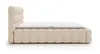 A side view of a beige upholstered bed with a tufted headboard and frame, set against a white background. Náhled obrázku produktu