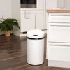 A white sensor trash can is placed on a dark wooden floor in a modern kitchen. Produktbild-Vorschau