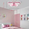 A child's bedroom with a butterfly-shaped ceiling lamp, a bed, and a wardrobe. Produktbild-Vorschau