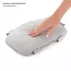A hand is shown pressing down on a soft, gray cushion, demonstrating its texture and ease of cleaning. Produktbild-Vorschau