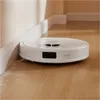 A white robot vacuum cleaner is cleaning a wooden floor next to a wall. Náhled obrázku produktu
